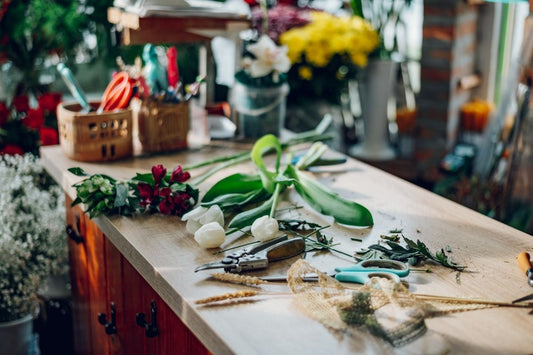 An image of a wooden table with floral maintenance equipments